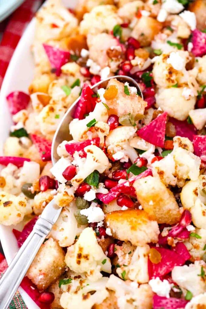 overhead shot of winter panzanella salad with a serving spoon in it