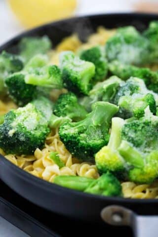 broccoli over pasta in a skillet
