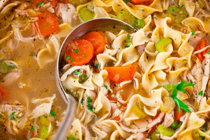 Homemade chicken noodle soup with carrots and celery.