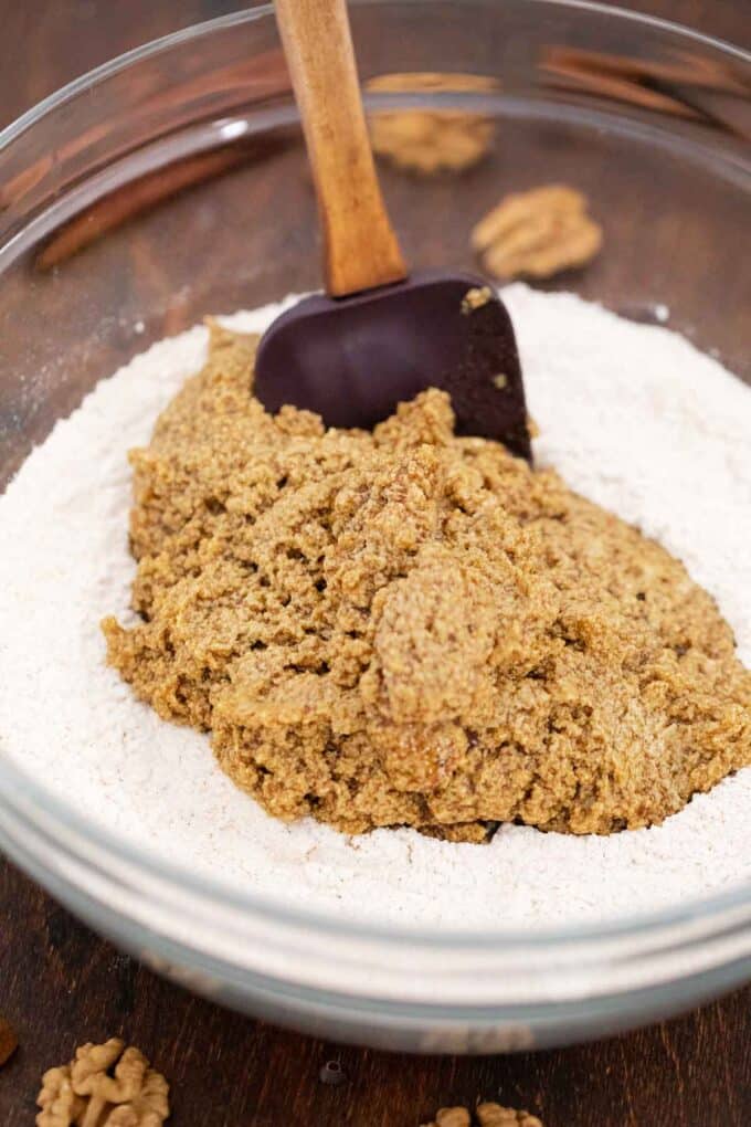 combining wet and dry ingredients in a bowl to make cookies