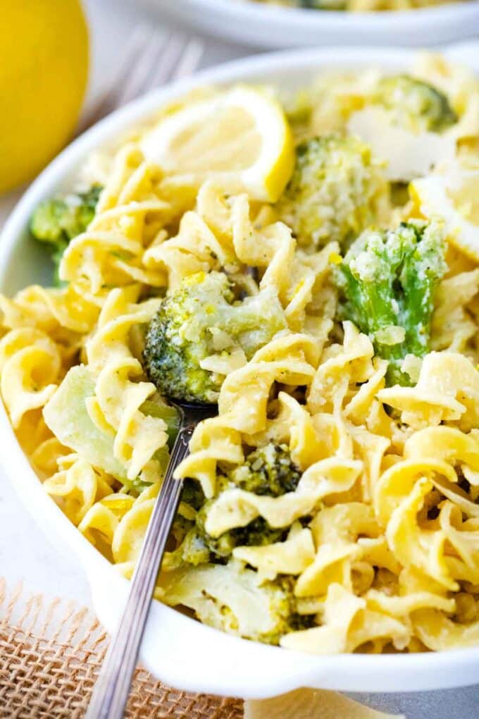 a plate with lemon broccoli pasta with a fork in it