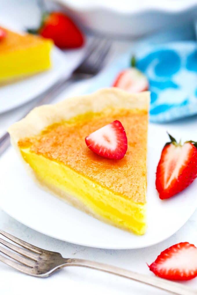 southern chess pie on a plate served with fresh strawberries