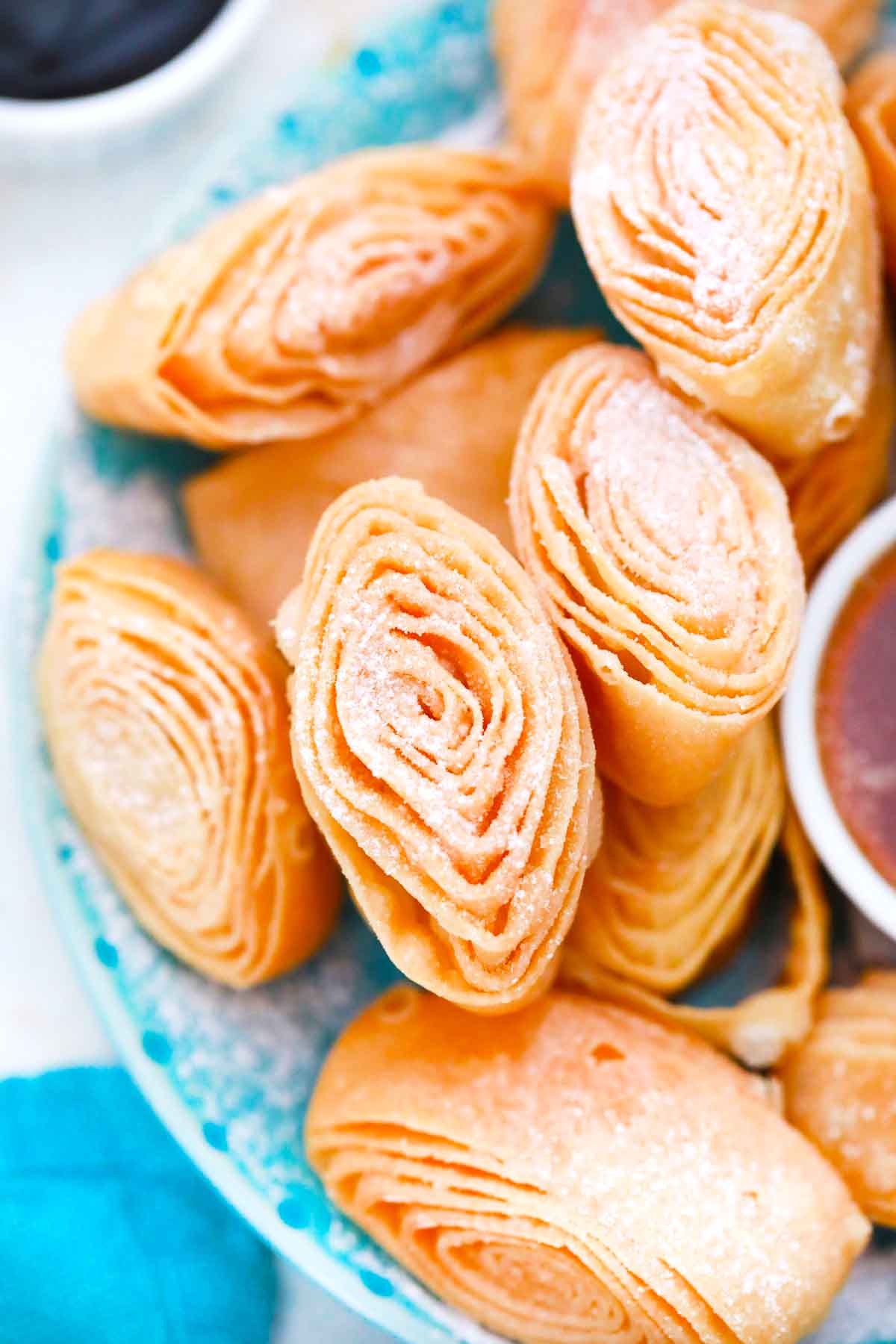 fried dough roses covered in powdered sugar