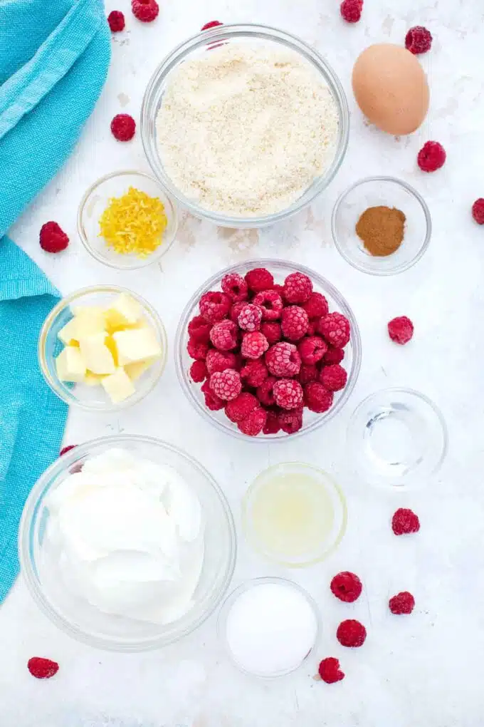 overhead shot of keto raspberry cheesecake bites ingredients in bowls on a table