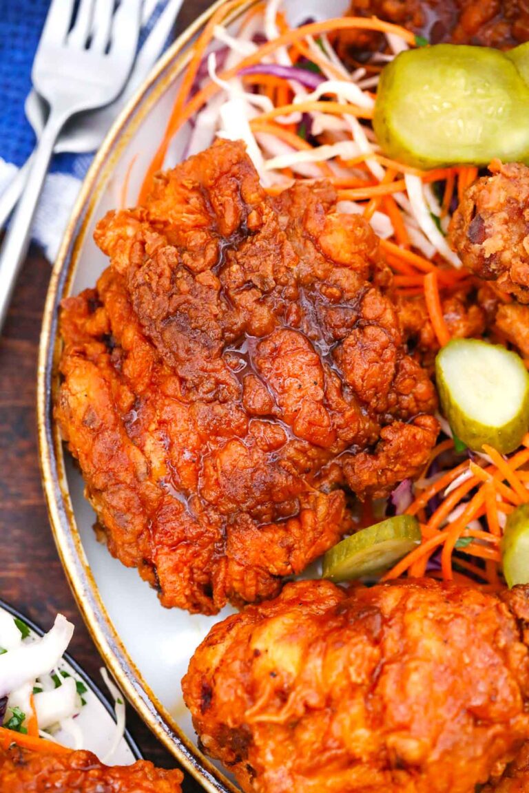 close shot of a golden brown crispy fried piece of nashville hot chicken