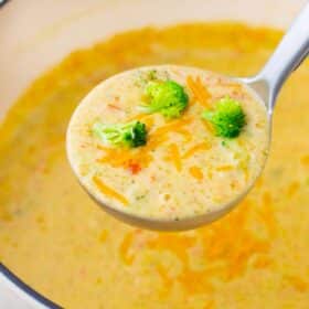 a ladle of creamy panera bread broccoli cheddar soup