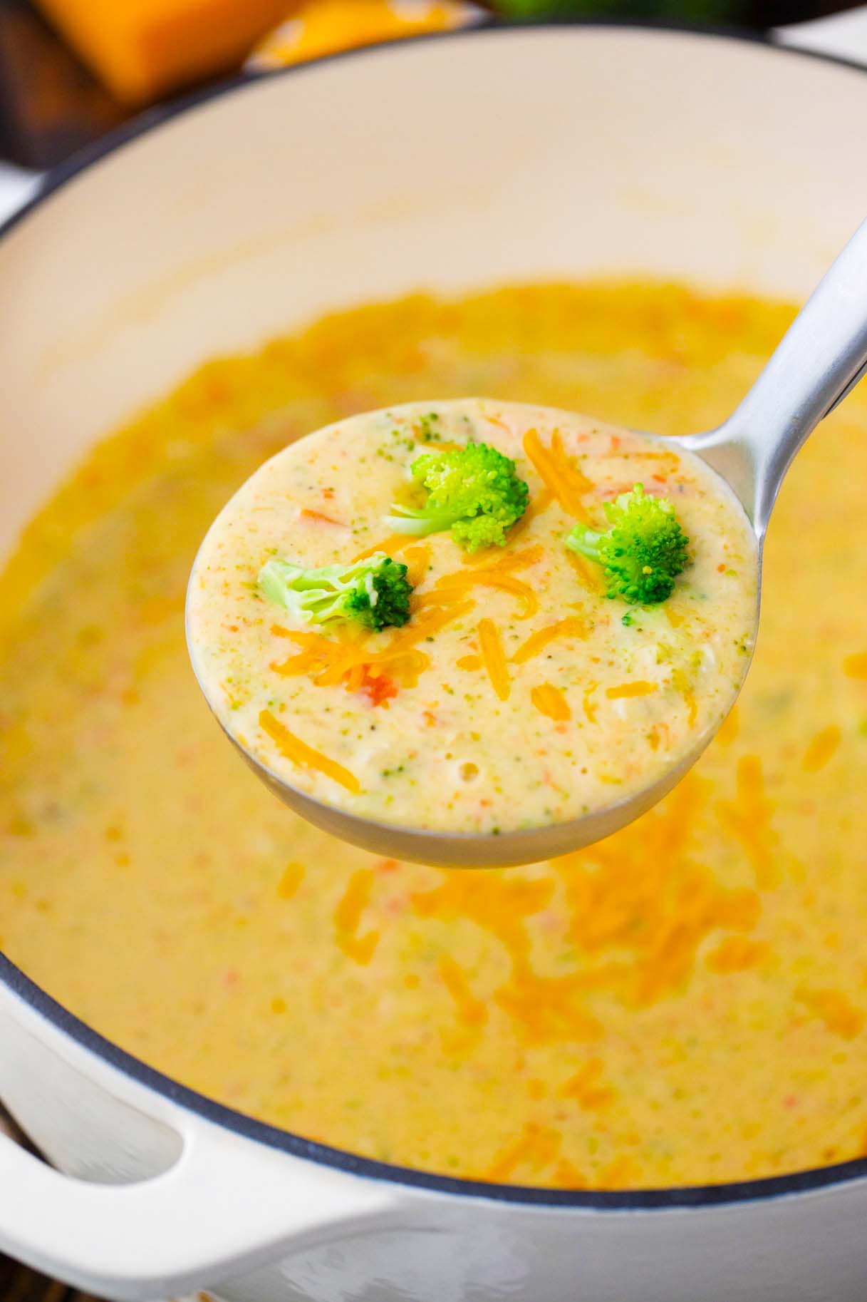 a ladle of creamy panera bread broccoli cheddar soup