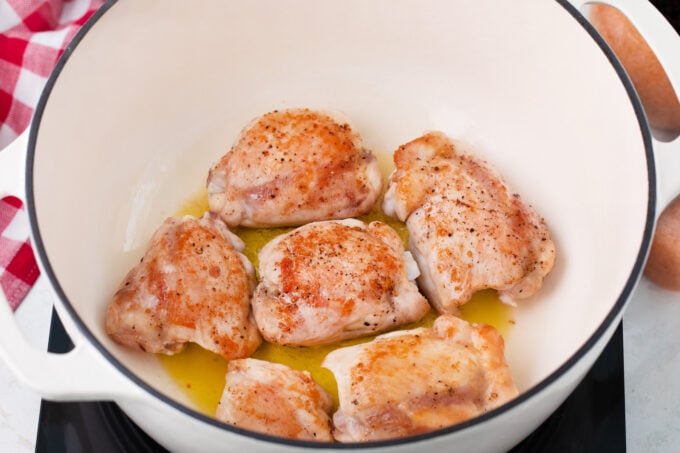 Sautéing chicken thighs.