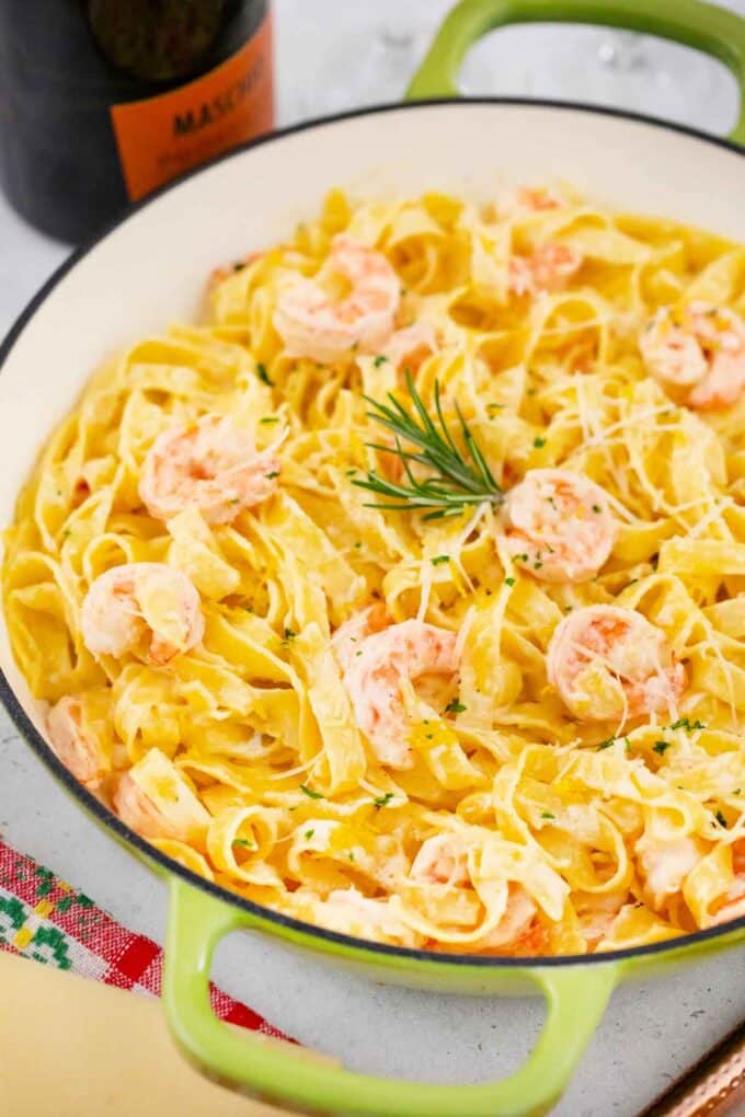 lemon champagne shrimp scampi in a skillet topped with fresh rosemary