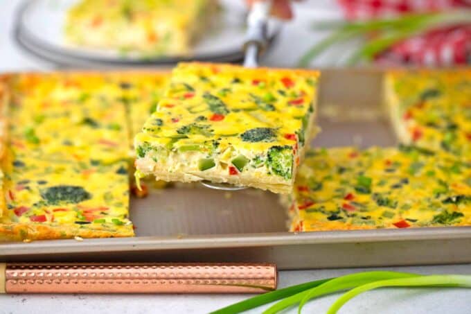serving a slice of sheet pan quiche