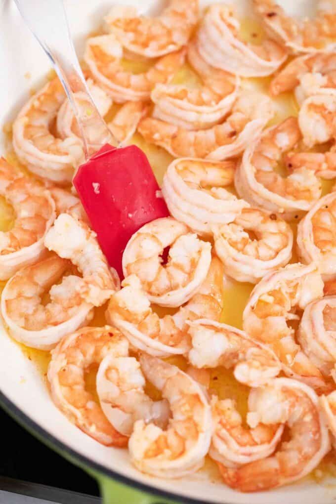 cooking shrimp in butter in a skillet