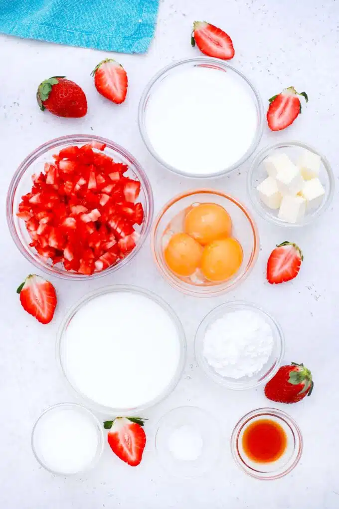 overhead shot of strawberry eclairs ingredients in bowls on a table