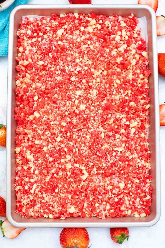 overhead shot of strawberry shortcake crumbs on a baking sheet