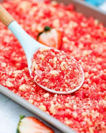 a spoonful of strawberry shortcake crumbs on a baking sheet