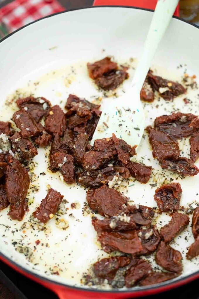 sautéing dried herbs and sun dried tomatoes in a skillet