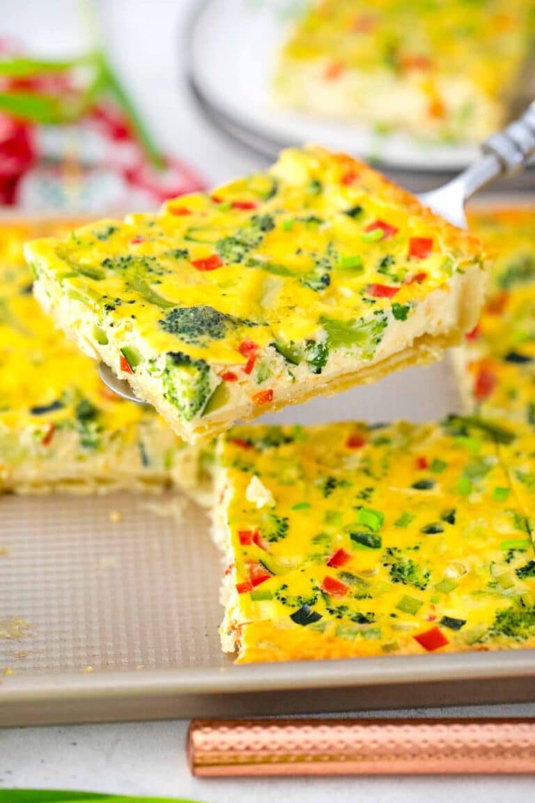 a slice of quiche on a serving spatula