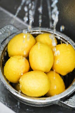 washing lemons in a colander