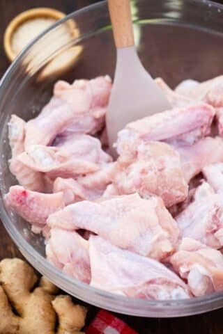 raw chicken wings in a bowl with baking powder
