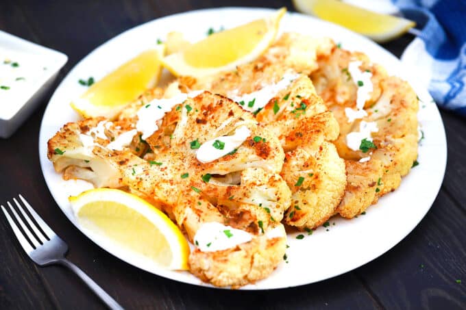 A plate of perfectly crispy cauliflower steaks.