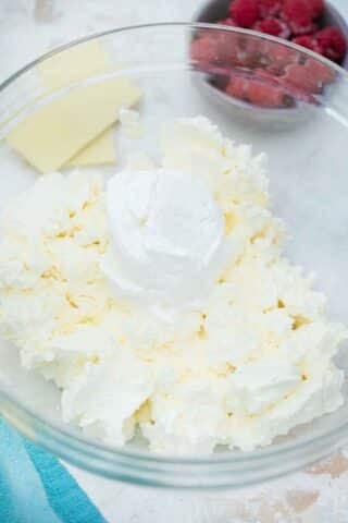 mixing sour cream into cream cheese