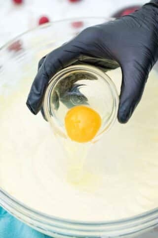 adding an egg to cream cheese mixture