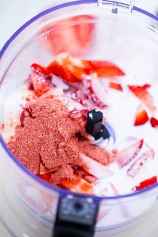 strawberry cheesecake chia pudding ingredients in a food processor