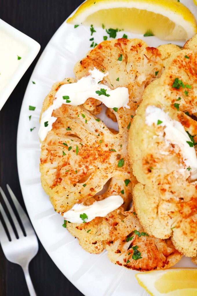Oven roasted cauliflower steak with white sauce.