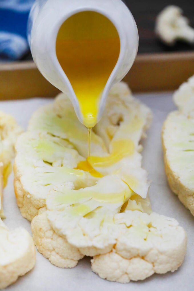 Seasoning cauliflower steak.