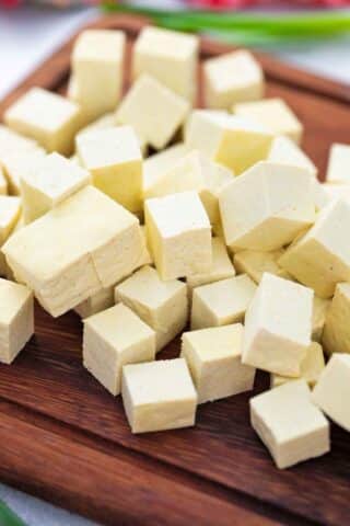 cubed firm tofu on a cutting board