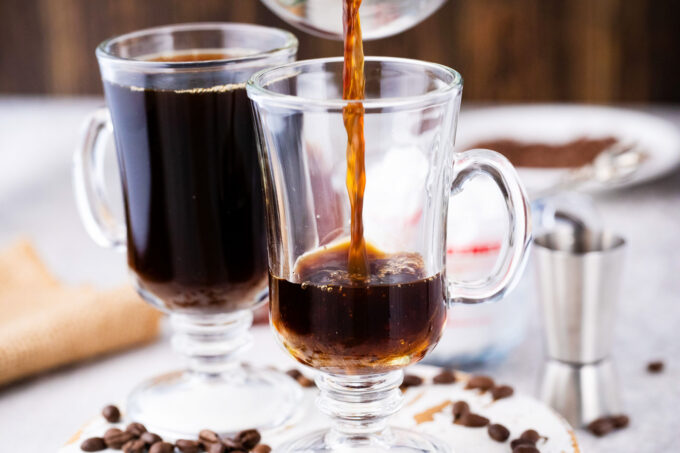 Pouring freshly brewed coffee in a mug.