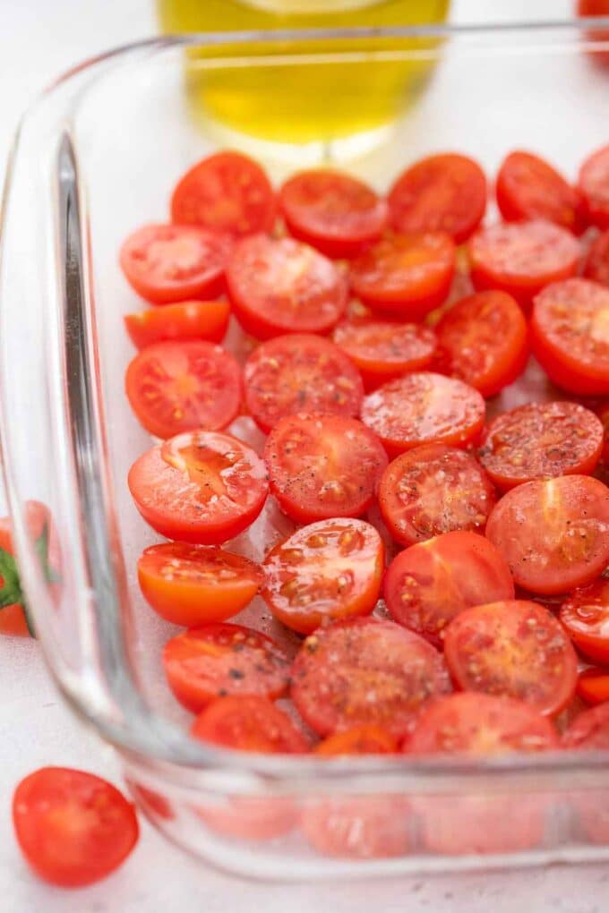 halved grape tomatoes in a roaasting pan
