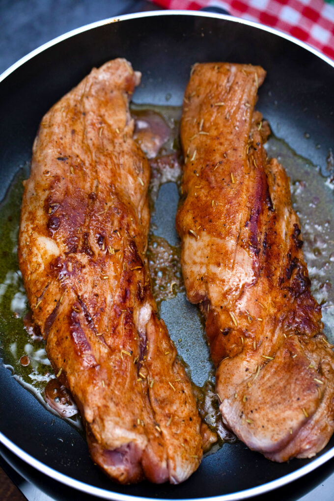 Searing pork tenderloins.