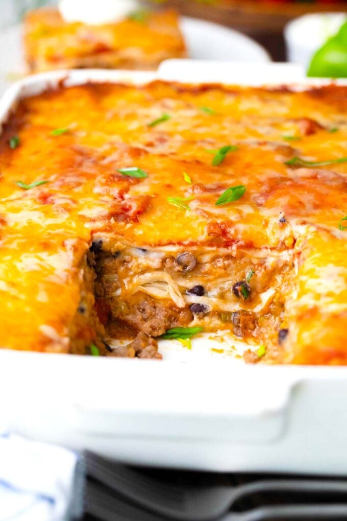 Taco lasagna in a casserole dish.