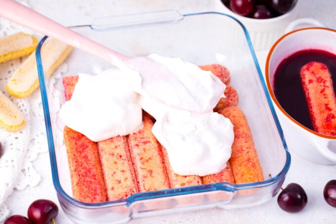 Assembling cherry amaretto tiramisu.