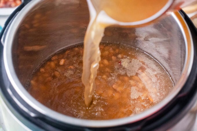 Adding liquid to dry beans in the instant pot.