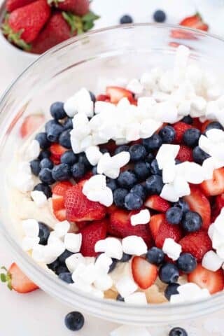 blueberries strawberries mini marshmallows in a bowl with pudding and yogurt