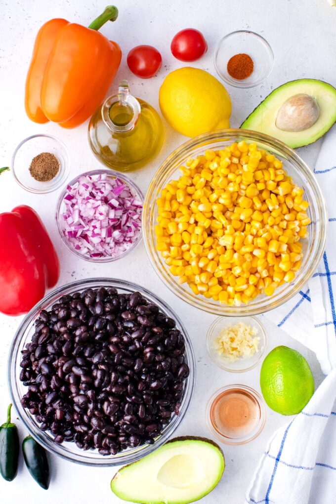 Mexican black bean salad ingredients in bowls on a table.