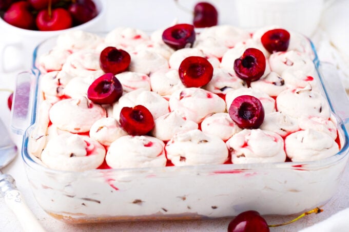 Cherry amaretto tiramisu in a pan topped with fresh cherries.