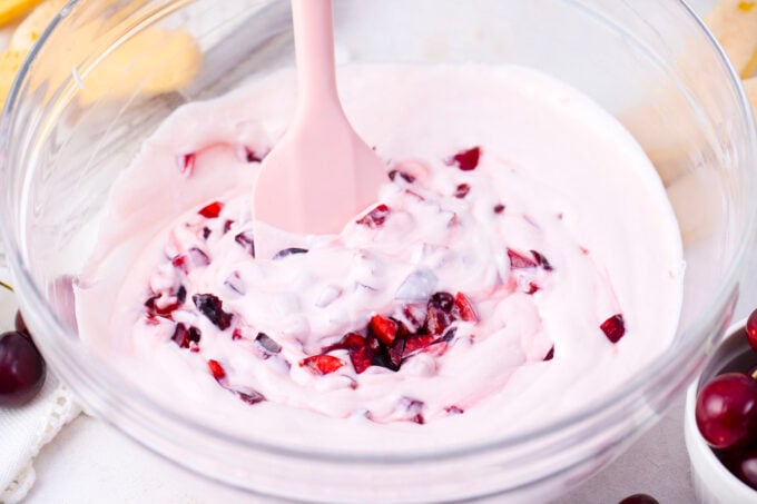 Mascarpone cream with fresh cherries in a bowl.