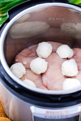 chicken breasts in the instant pot topped with cream cheese