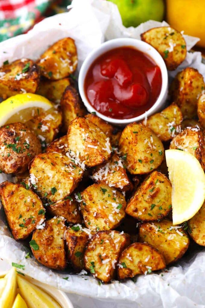 crispy air fried potatoes with ketchup and lemon wedges