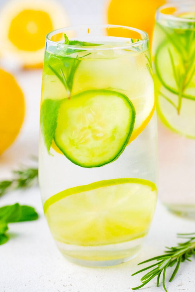 A glass of cucumber rosemary detox water.