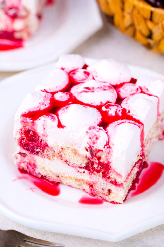 Cherry amaretto tiramisu slice drizzled with cherry sauce.
