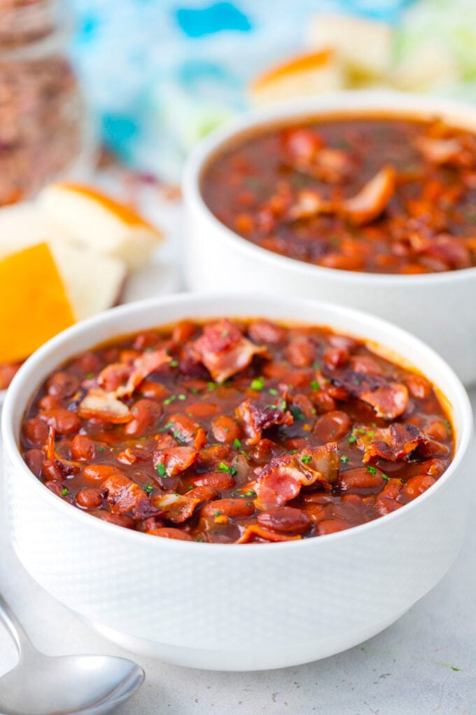 Bowls of instant pot BBQ baked beans with bacon.