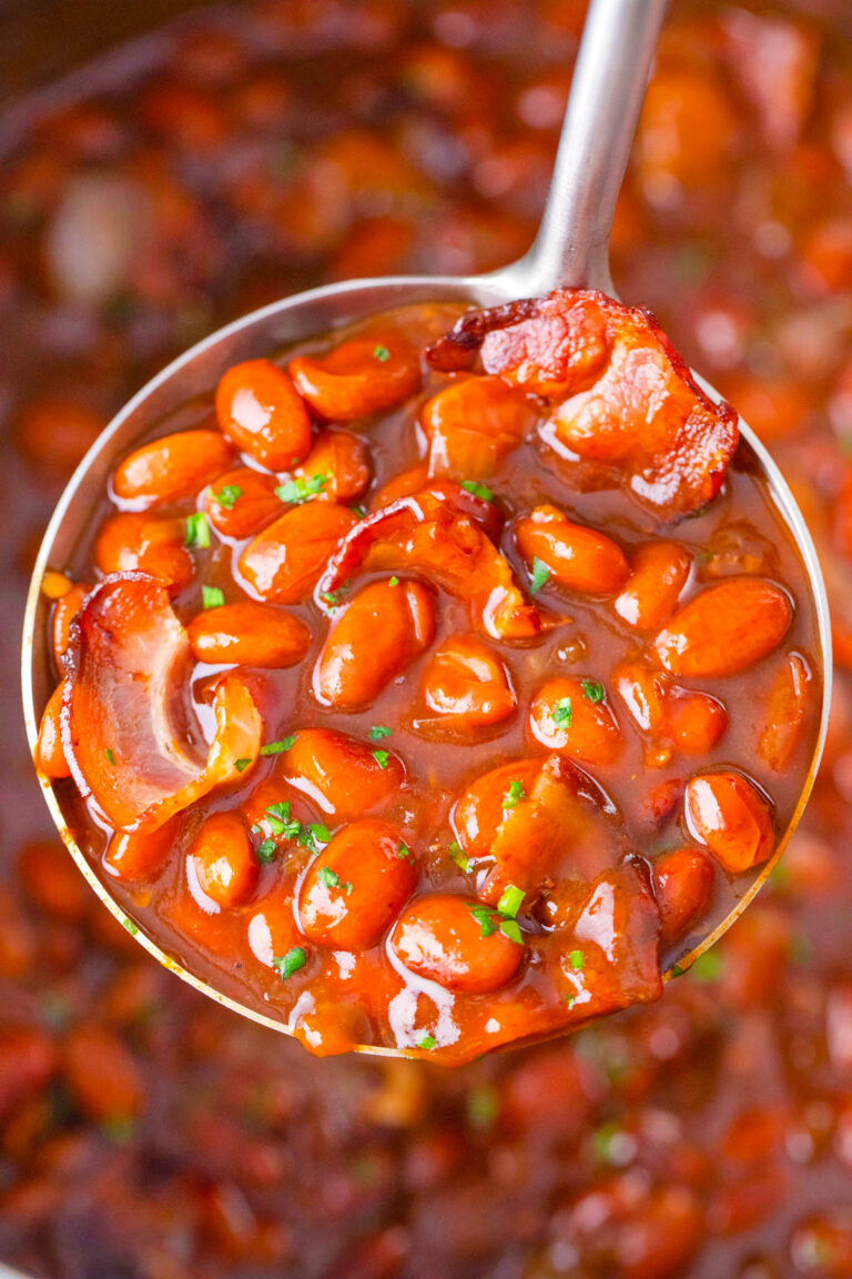 A ladle of instant pot baked beans with bacon.