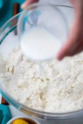 adding milk to flour and shortening mixture