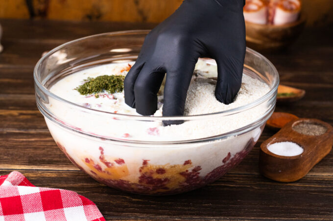 Mixing by hand the ingredients for meatloaf.