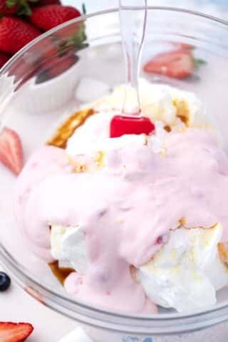 mixing vanilla pudding with strawberry yogurt in a bowl