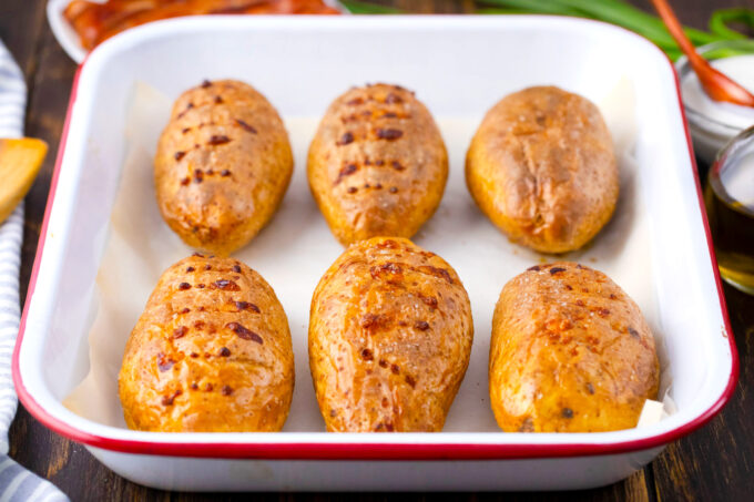 Perfectly oven baked potatoes in a baking dish.
