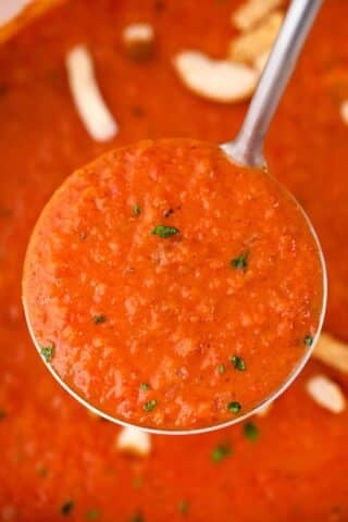 a ladle of panera bread creamy tomato soup